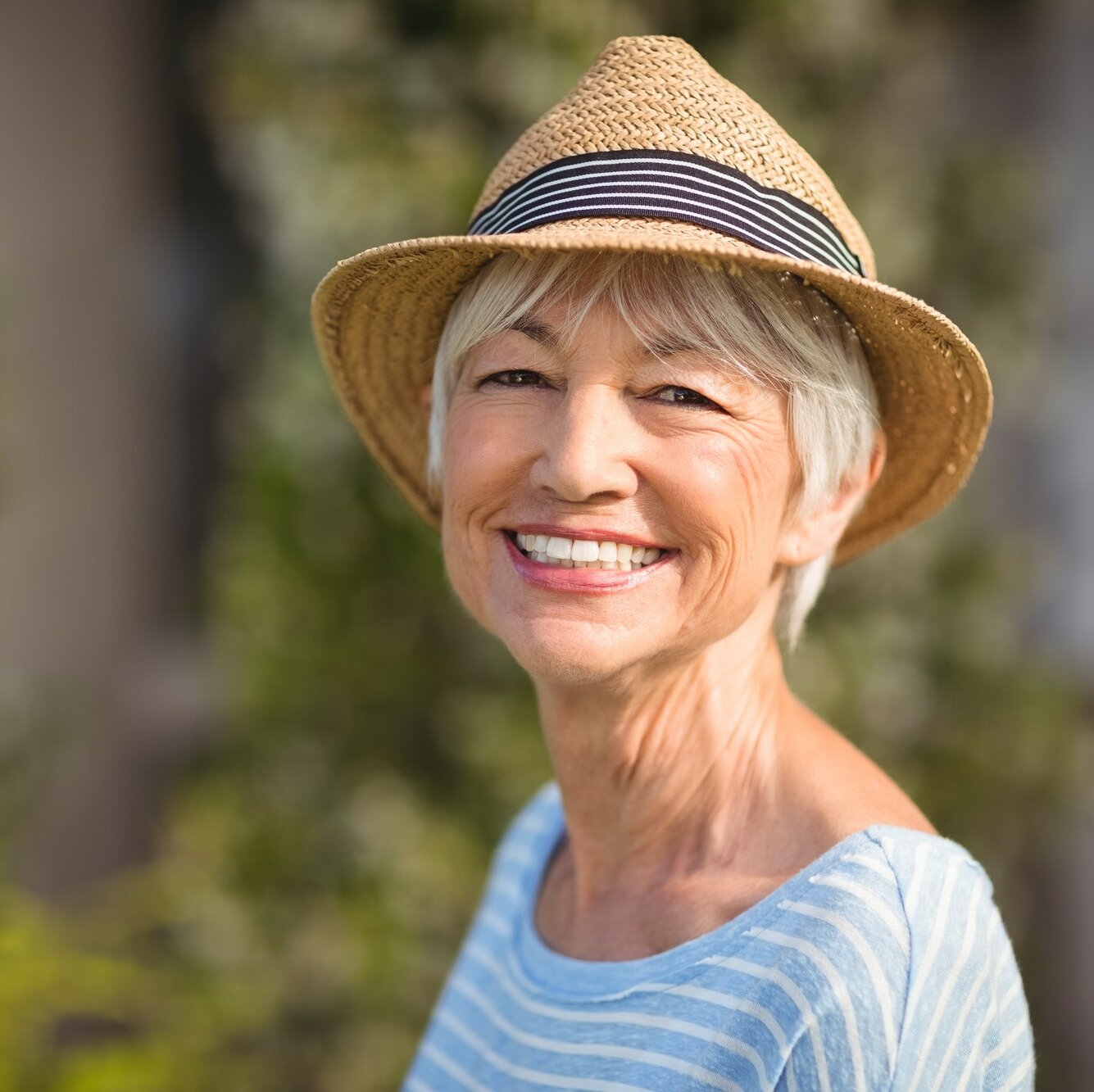Happy senior woman in straw hat